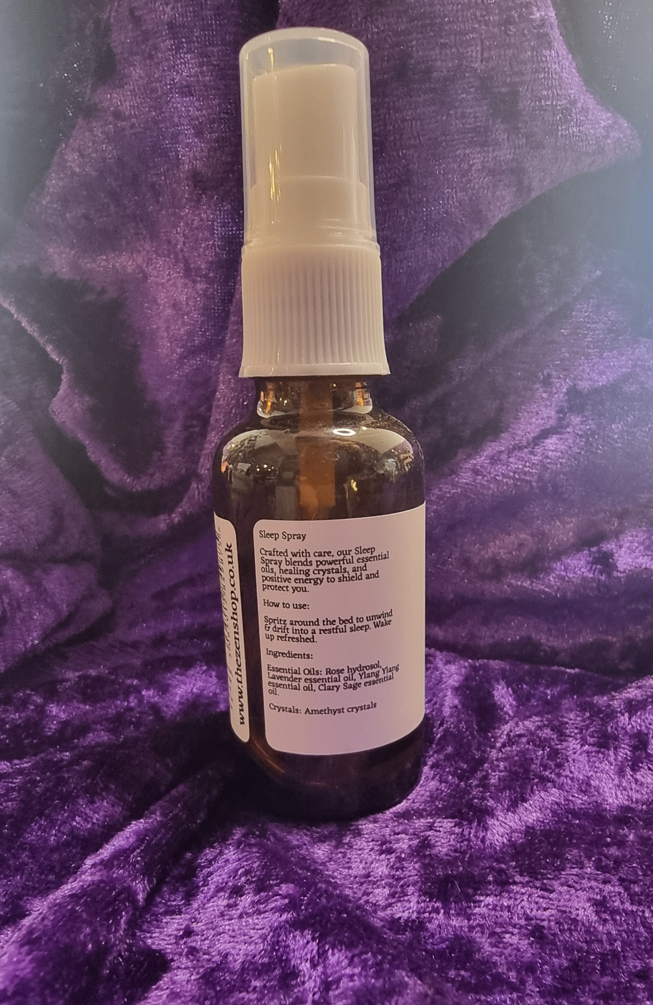 Small brown bottle with a white label on a purple textured surface