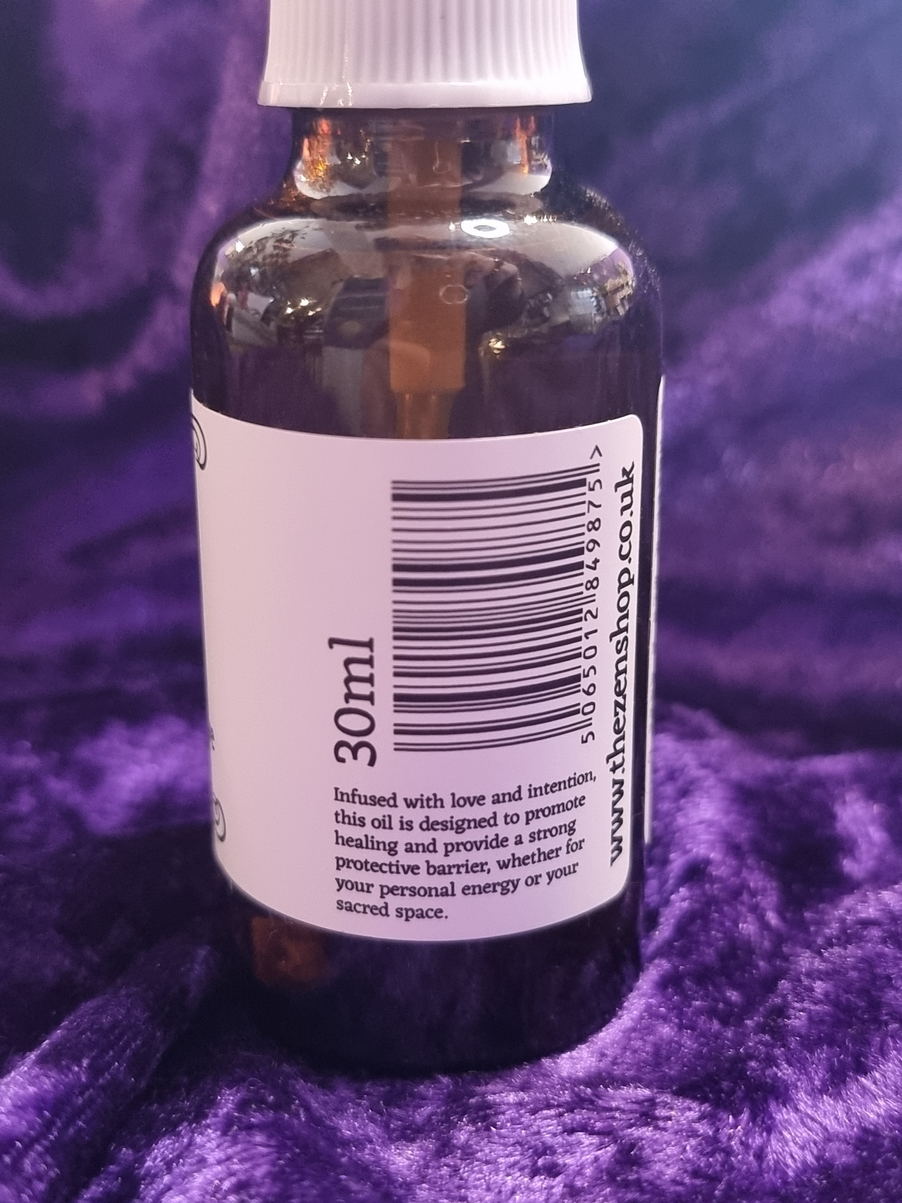 Small bottle with a label on a purple textured background