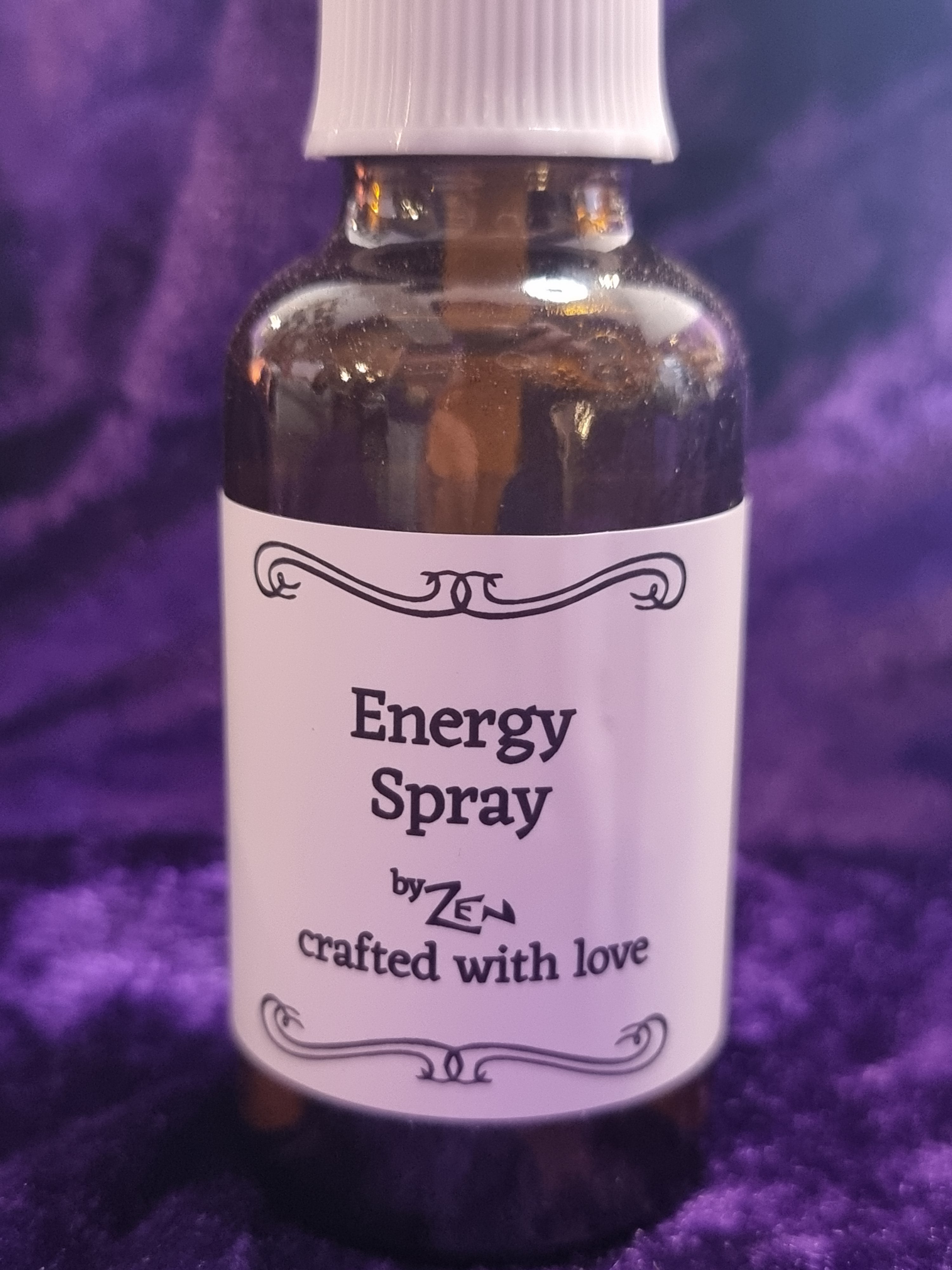 Bottle of 'Energy Spray' with a purple label on a purple background