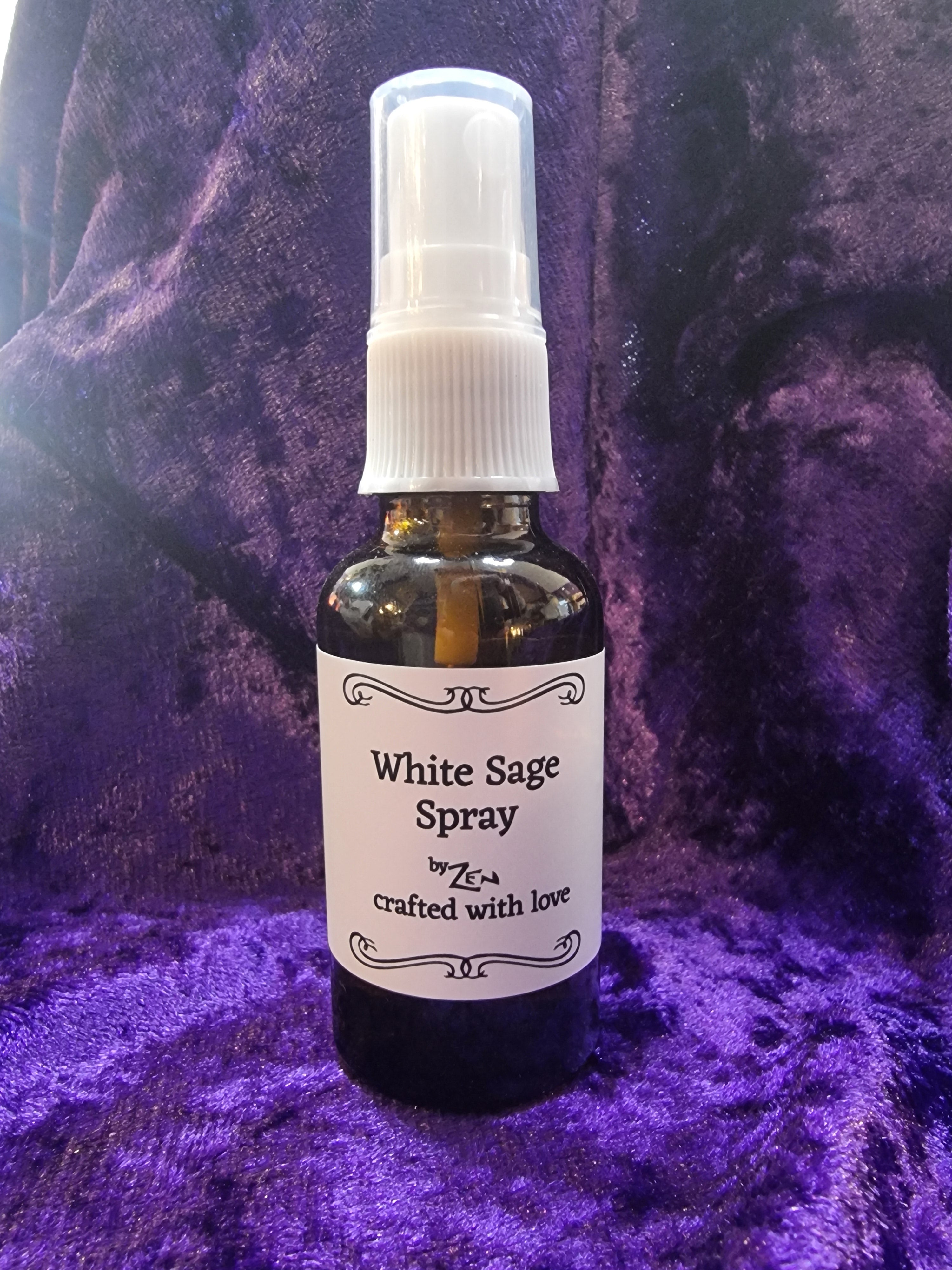 White Sage spray bottle on a purple textured surface