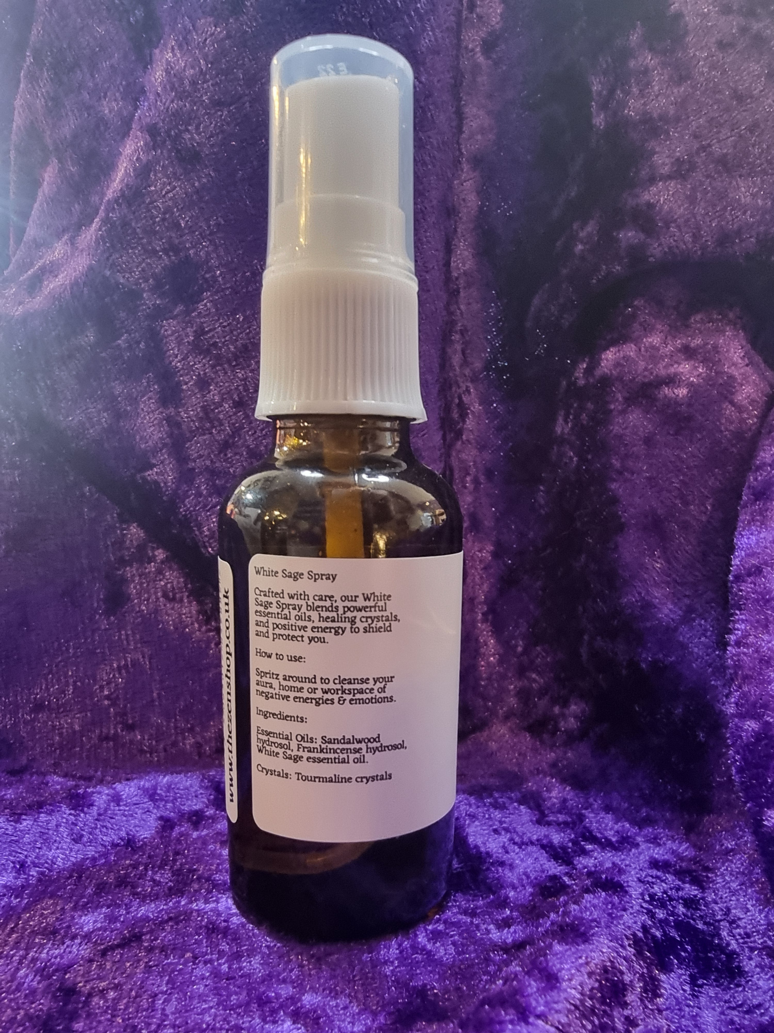 Small bottle with a spray nozzle on a purple textured surface