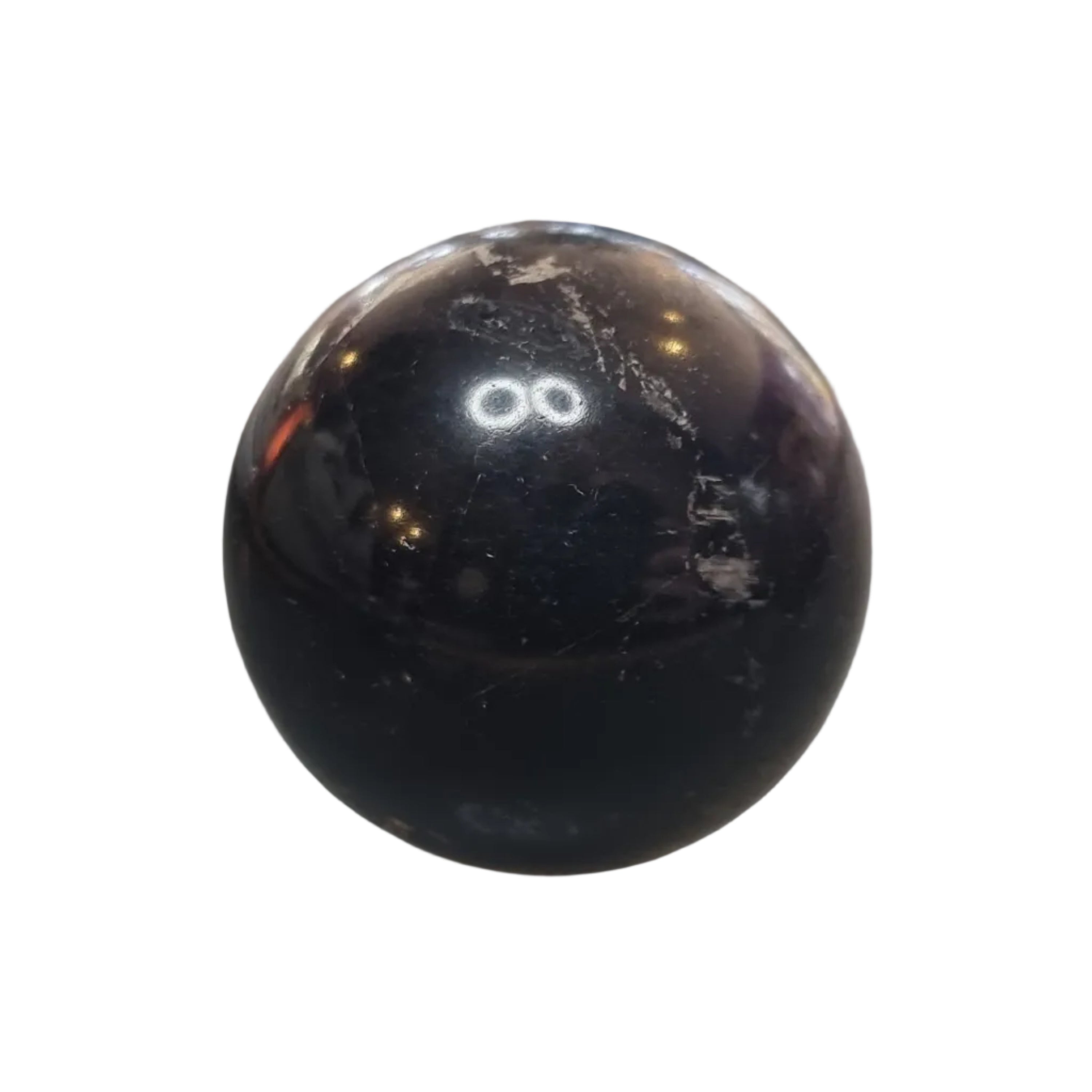 Black marble-like sphere on a reflective surface