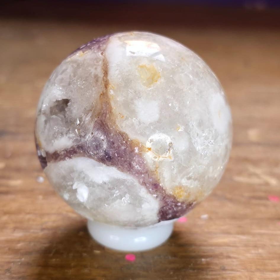 Crystal ball with a white base on a wooden surface