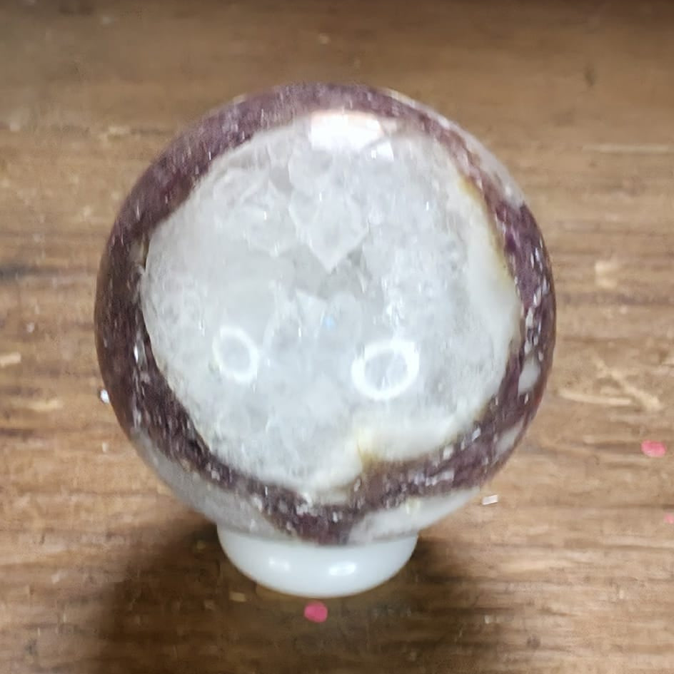 Decorative knob with a textured surface on a wooden surface