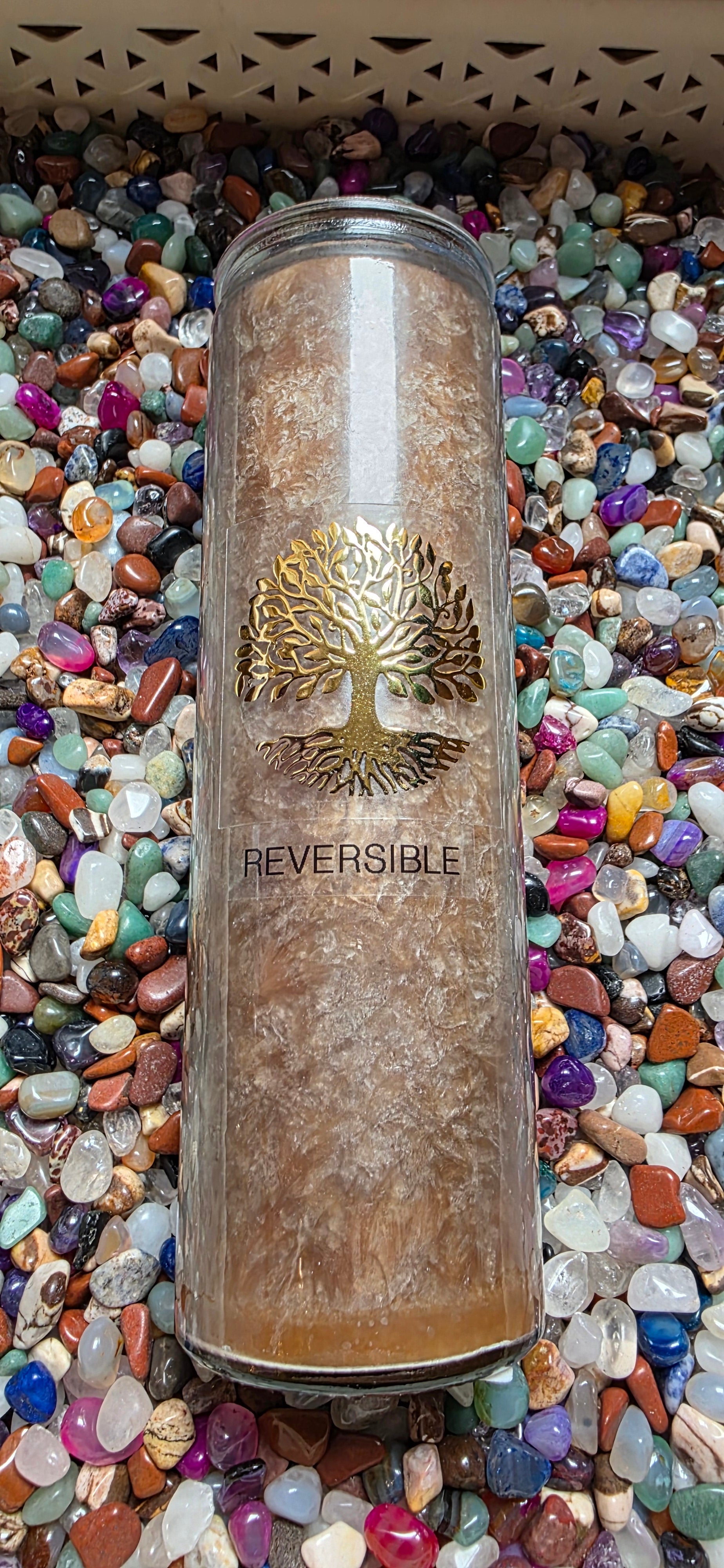 Reversible product container with tree design on a bed of multicolored stones