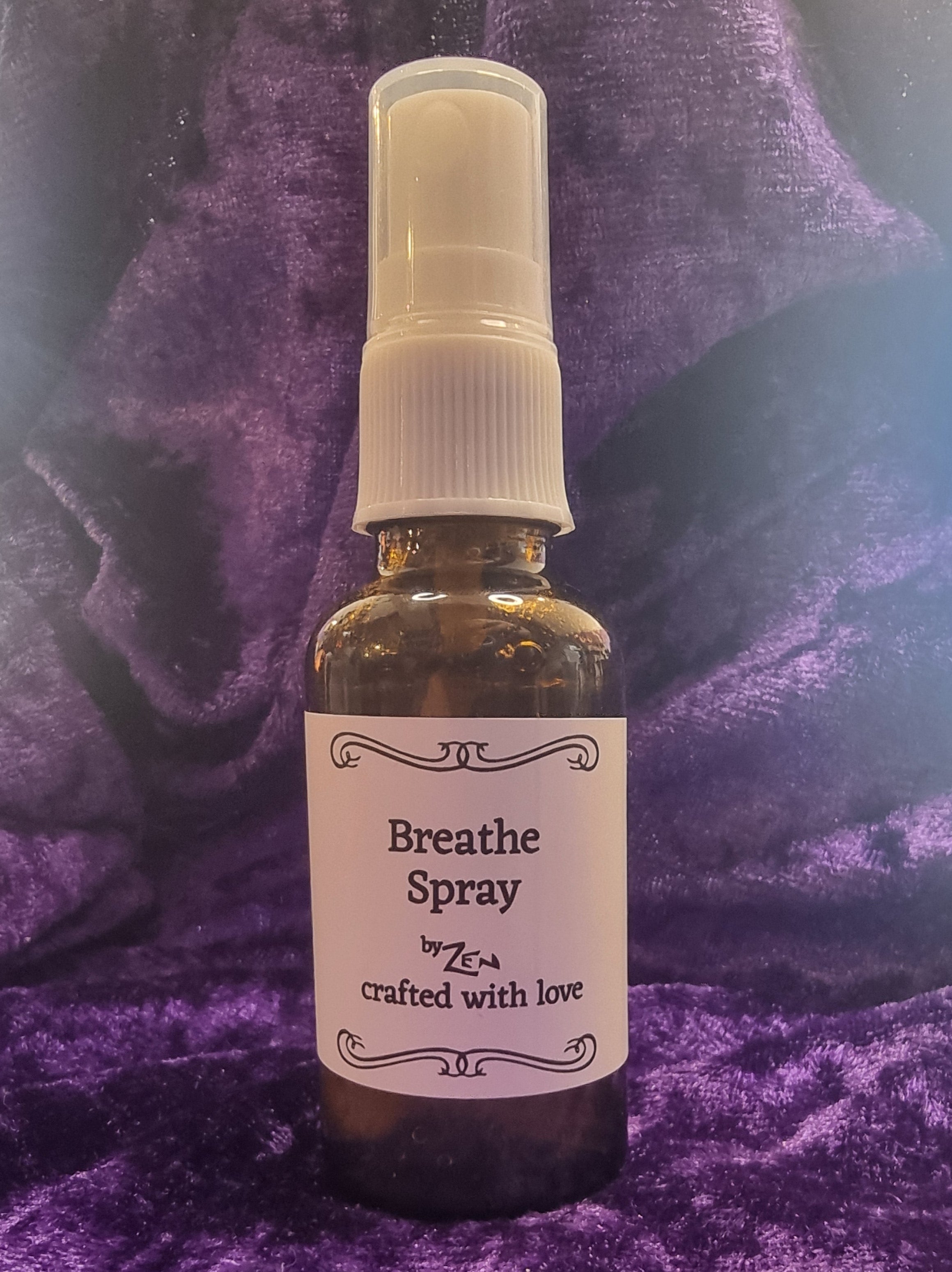 Bottle of breathe spray on a purple textured surface