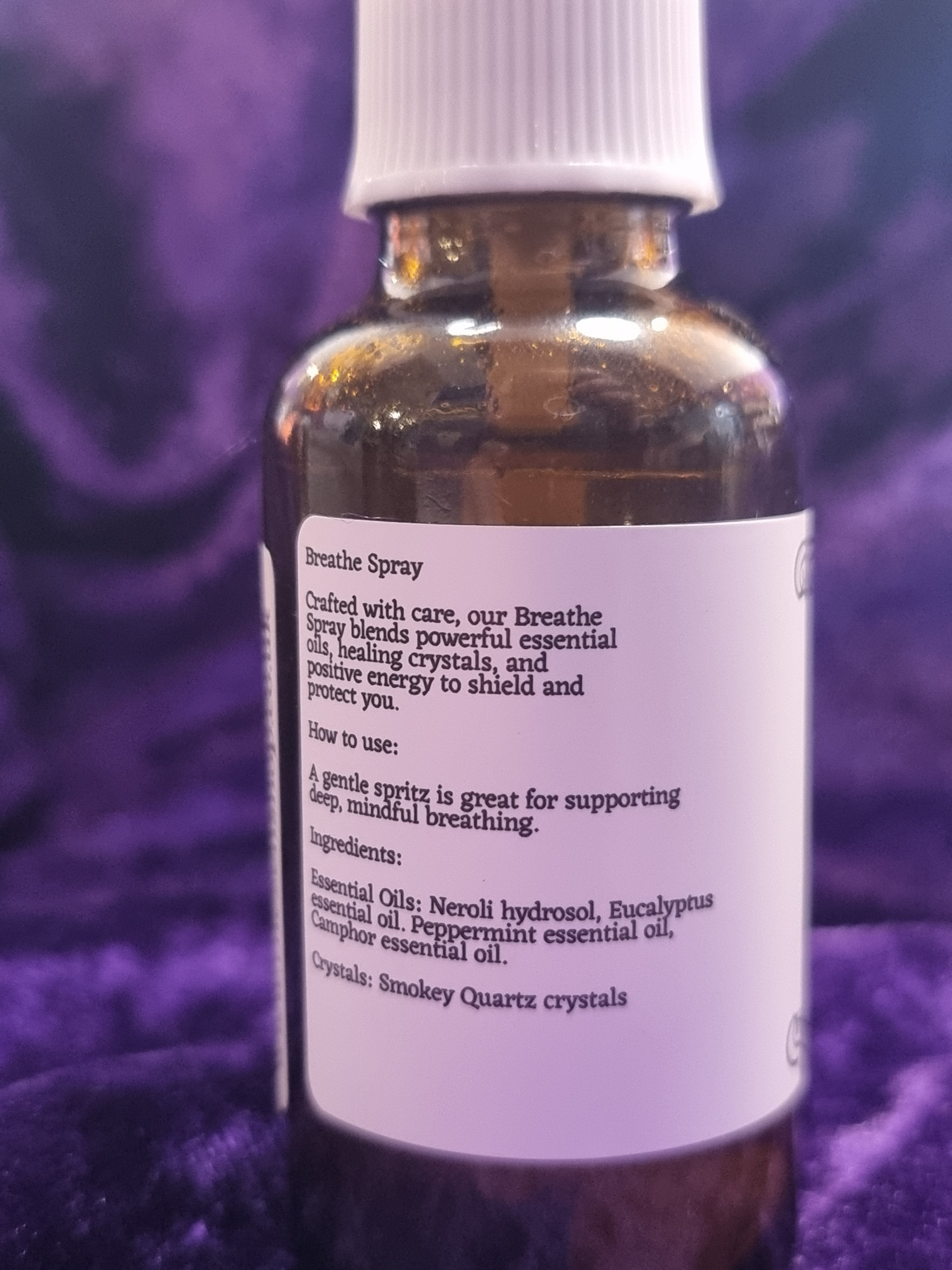 Bottle of essential oil with a label on a purple background