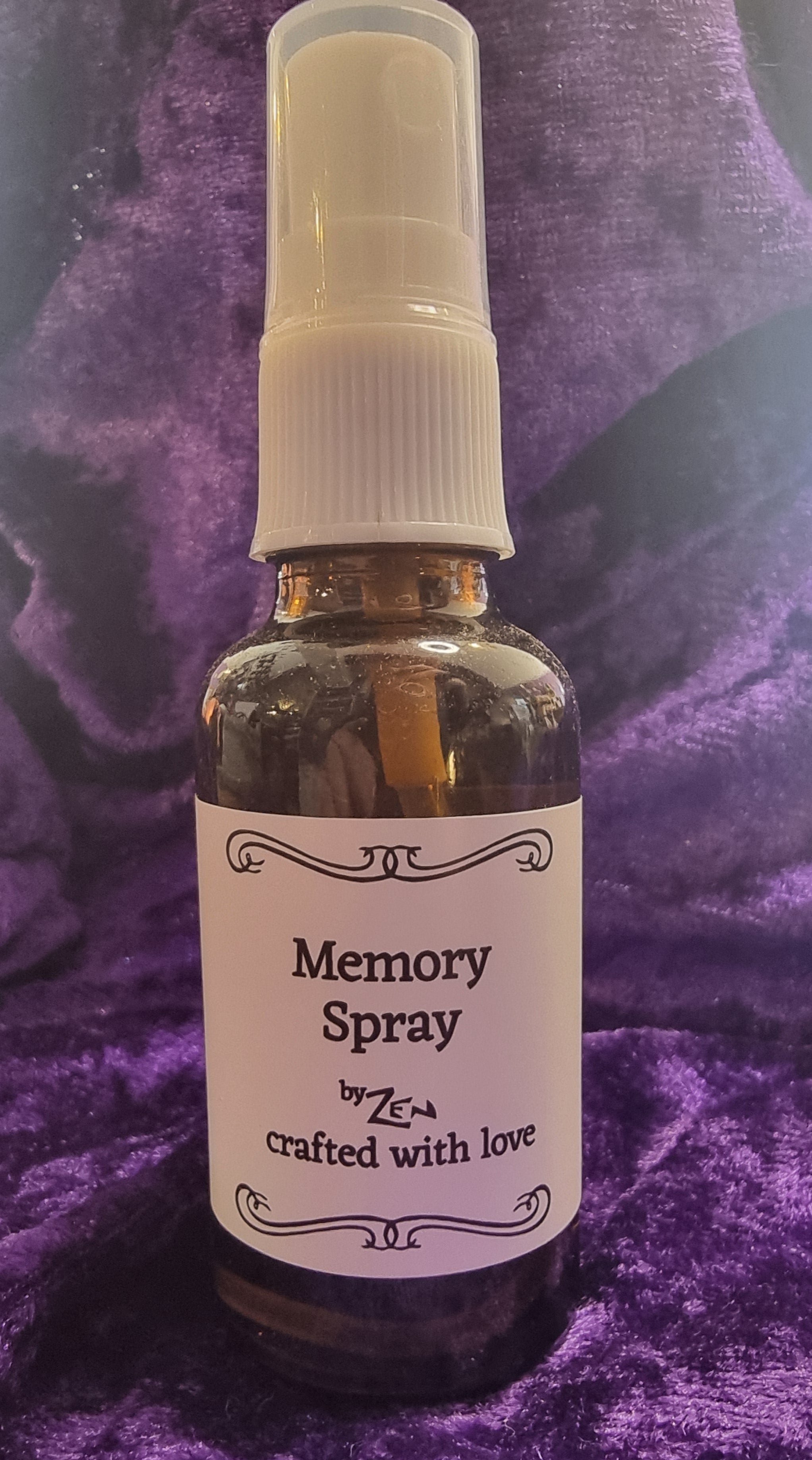 Bottle of 'Memory Spray' on a purple textured surface