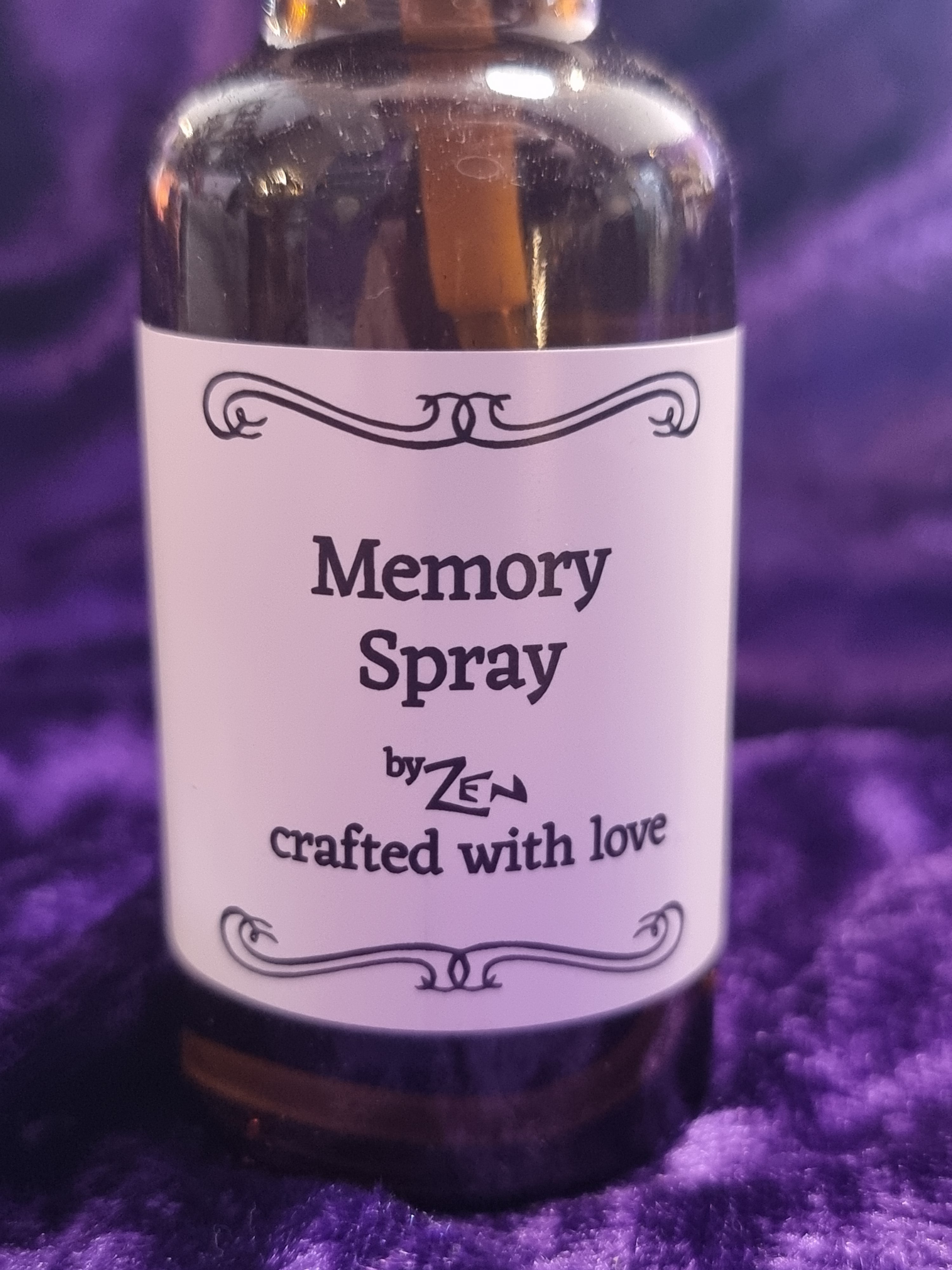 Bottle of 'Memory Spray' by Zen on a purple textured background