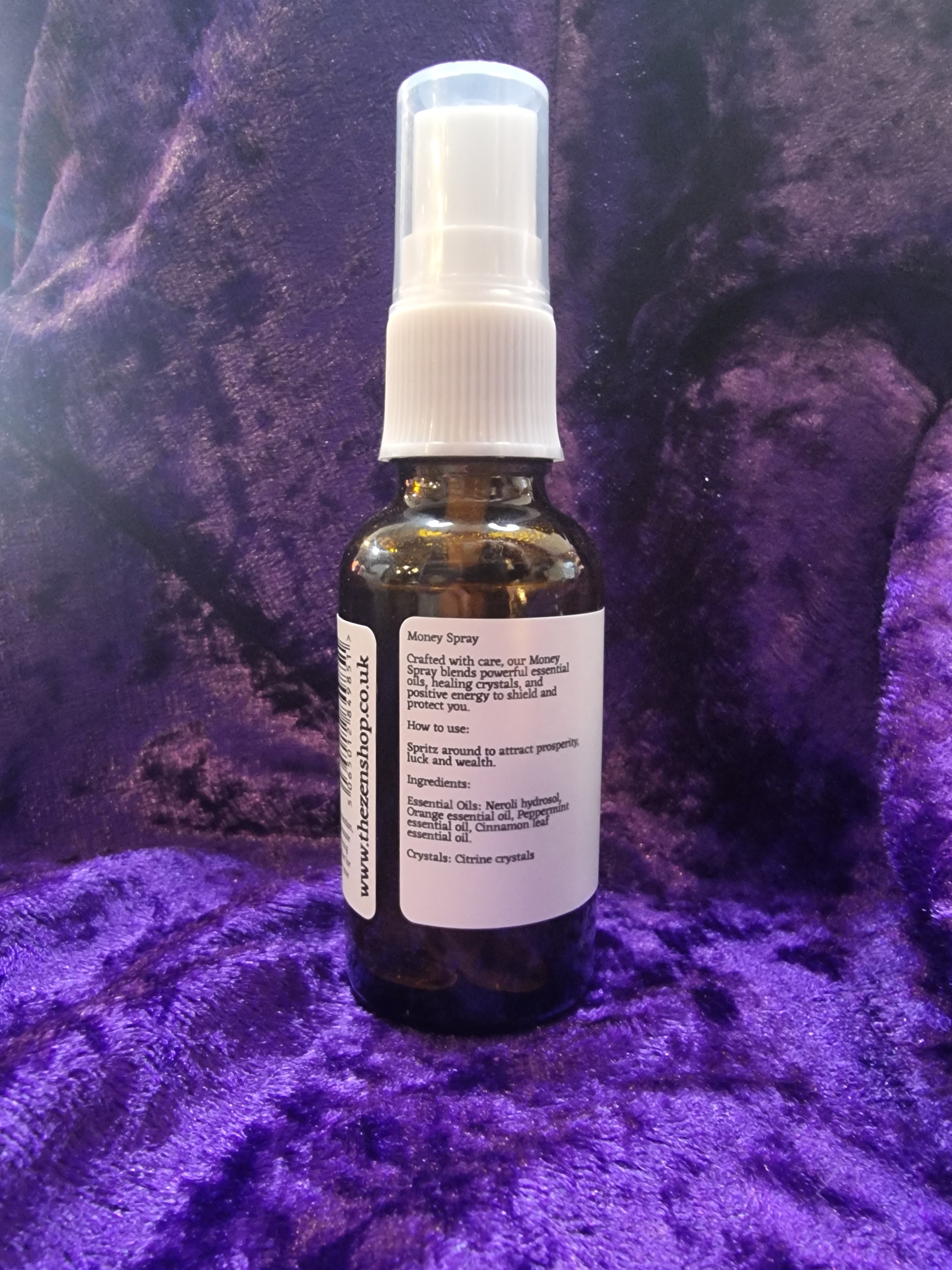Small bottle with a spray nozzle on a purple textured surface