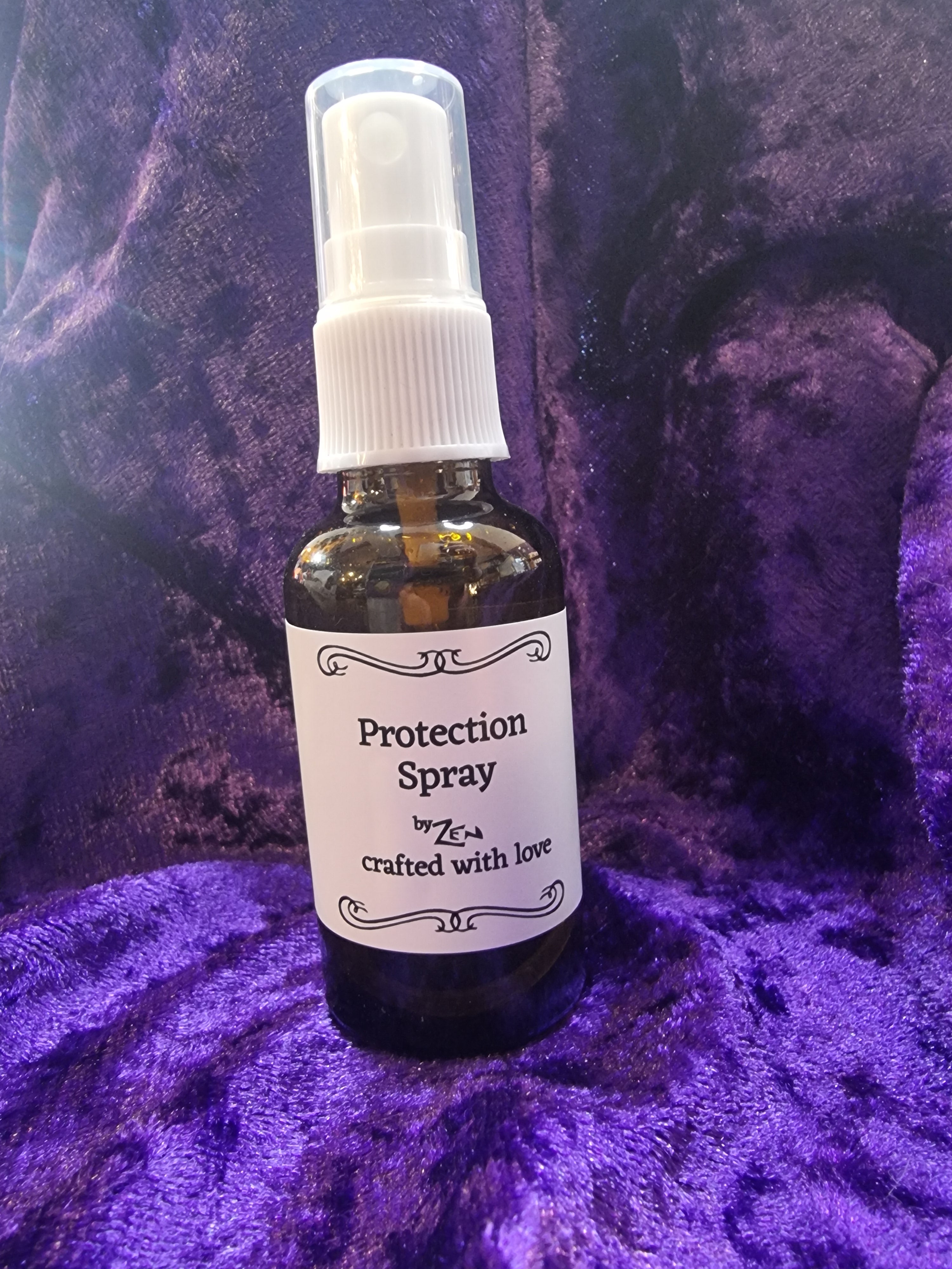 Protection spray bottle on a purple textured surface