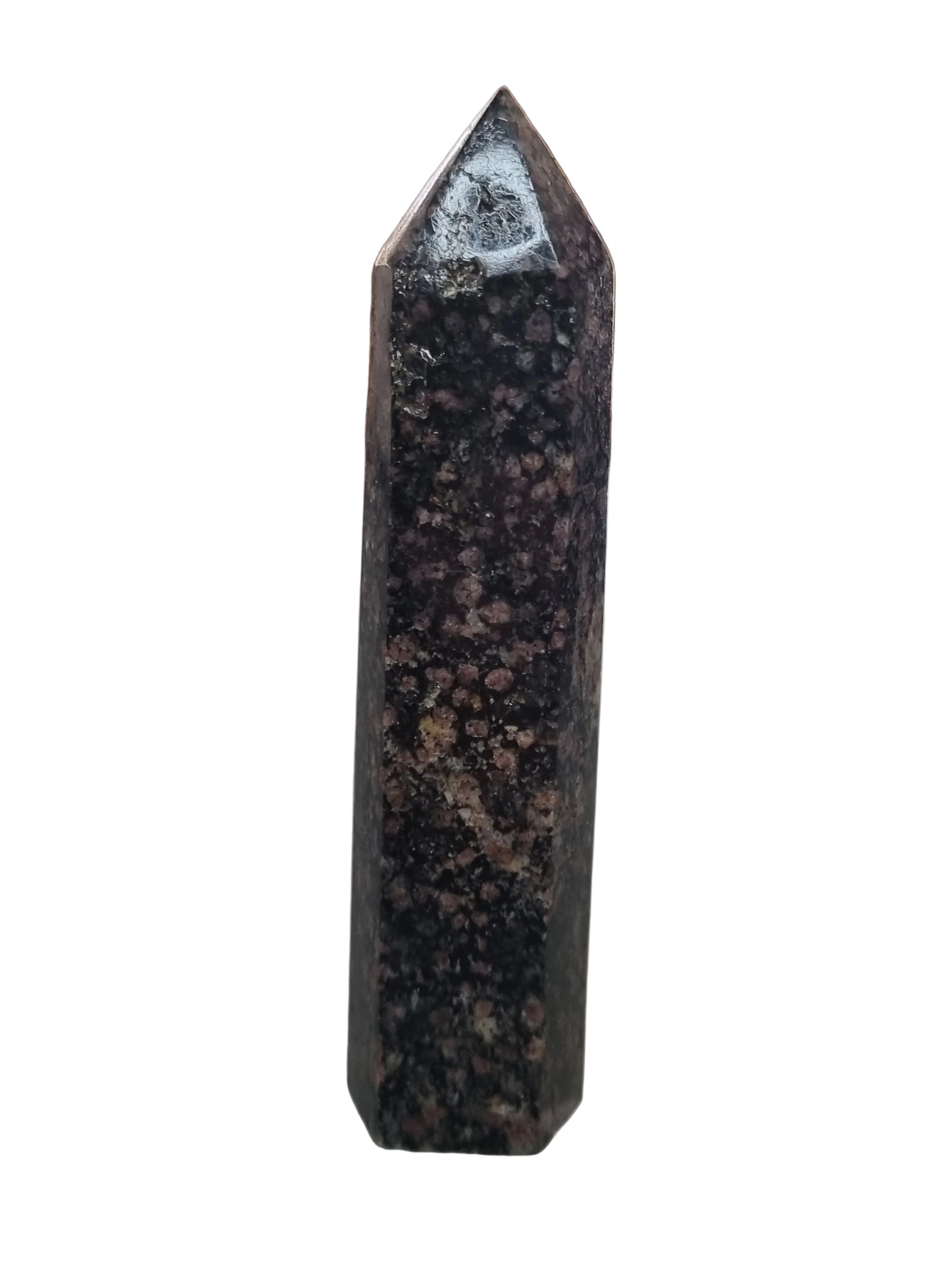 Polished crystal pyramid on a reflective surface with a blurred background