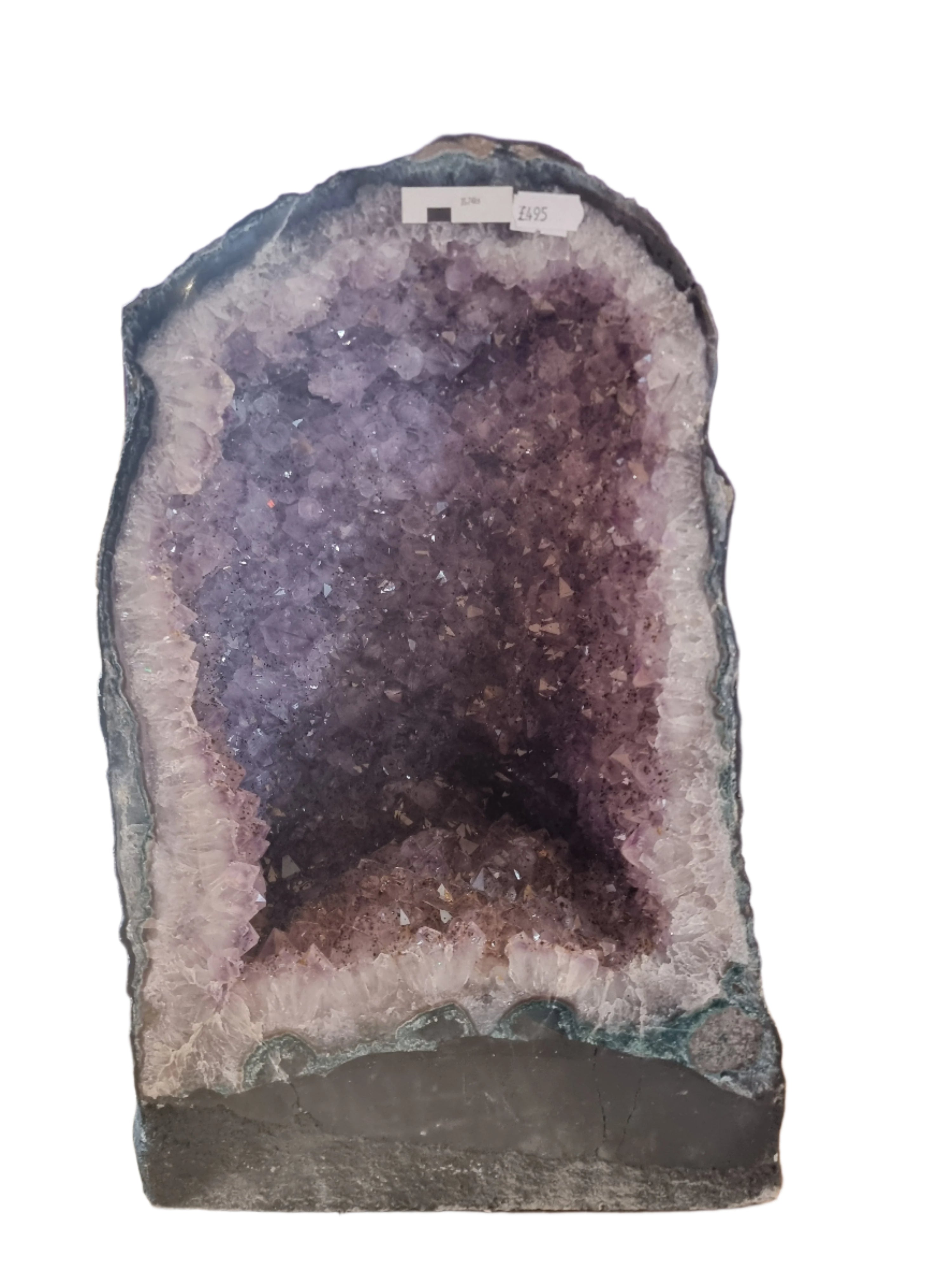 Geode with purple crystal inside on a wooden surface