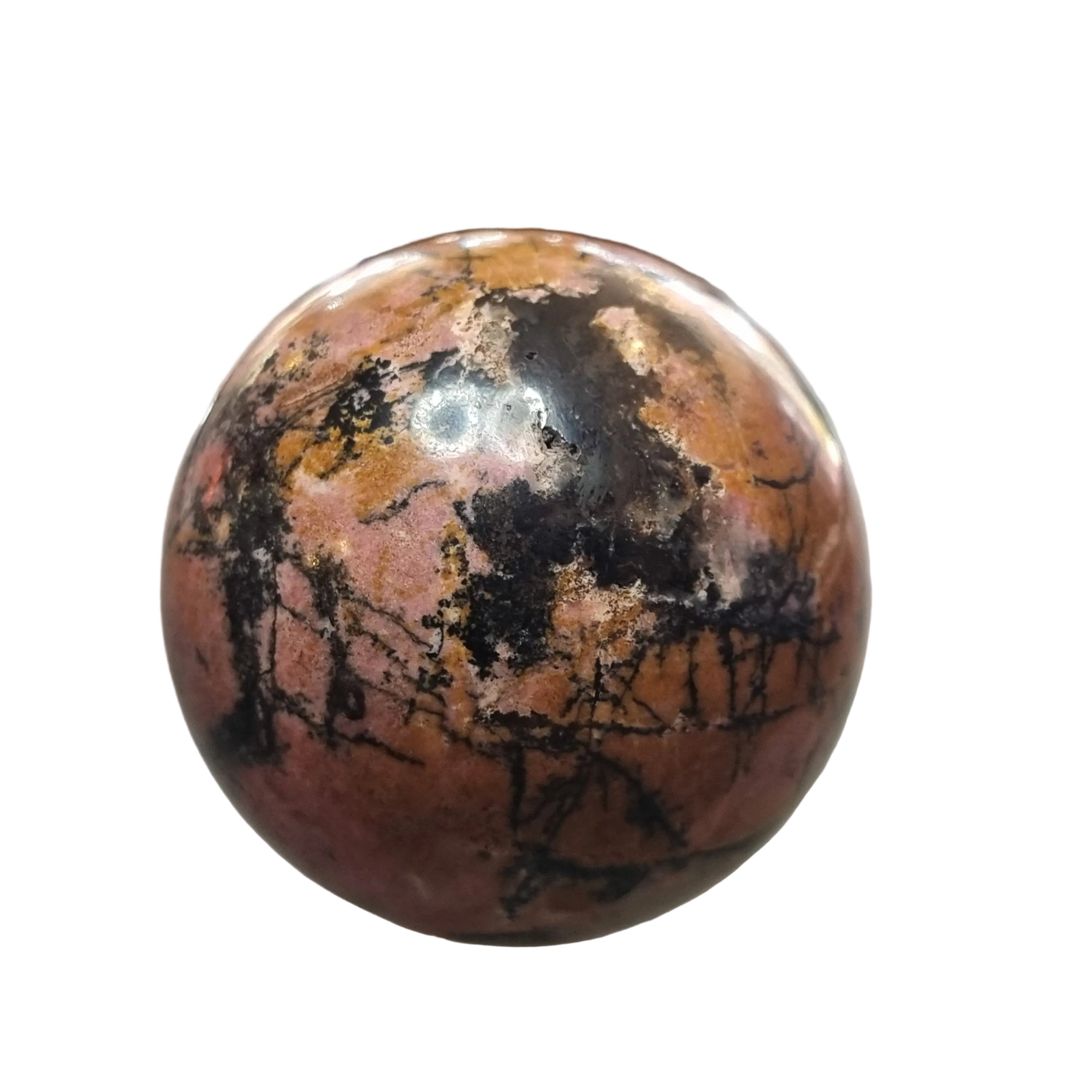 Round, multicolored stone on a reflective surface with a blurred background